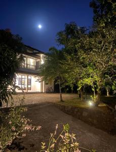 a house at night with the moon in the sky at Beachside Stay Steps From Mawella Bay, Tangalle #thisisnotahotel in Mawella +32 photos