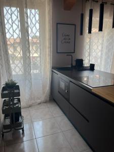 a kitchen with a counter top and a window at Appartamento i13-C in Magenta +8 photos