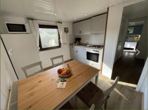 a kitchen with a table with a bowl of fruit on it at Ferienhaus Locke in Sassenberg