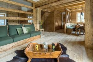 a living room with a couch and a table at Rifugio Tofane - Dolomiti Skyline in Cortina dʼAmpezzo +10 photos