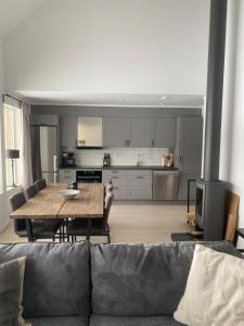 a living room with a couch and a table and a kitchen at Sälen Vintergatan 744 Lindvallen in Sälen +7 photos
