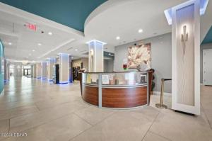 a lobby with a counter in the middle of a building at Spectacular Oceanfront Studio w/kitchenette in Daytona Beach +36 photos