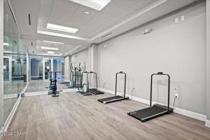 a gym with a row of exercise bikes in a room at Spectacular Oceanfront Studio w/kitchenette in Daytona Beach