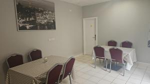 a dining room with tables and chairs and a picture on the wall at Hillfort Hostel in Baltinglass