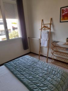 a bedroom with a bed and a window and a ladder at Peaceful room, Thuir centre, view Le Canigou in Thuir