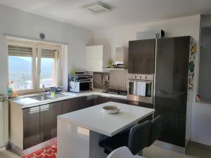 a kitchen with stainless steel appliances and a table at Dimora dei Visconti in Sarrotino