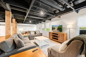 a living room with a couch and a tv at New Baileys Harbor Home, 1 block DT with Huge Yard in Baileys Harbor