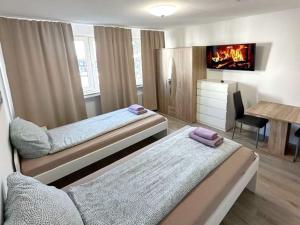 a bedroom with two beds and a fireplace at Beautiful apartment in Bergkamen bei Dortmund in Bergkamen
