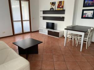 a living room with a couch and a table at La Fontana apartments in Fiumelatte