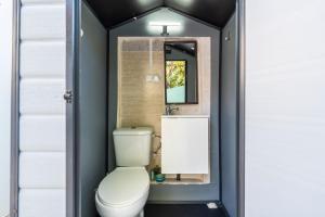 a bathroom with a toilet and a mirror at Loft Kandy 2 in Calafell +12 photos