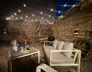 a room with a couch and a table with lights at A Frame Halmeag in Hălmeag