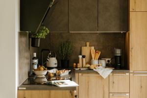 a kitchen with a counter with food on it at BURSZTYNOWA-PRZYSTAŃ in Lubiatowo