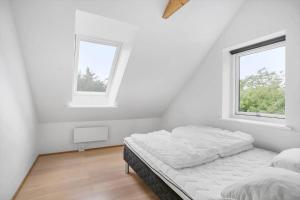 a white room with two beds and two windows at JB1031-Fjerritslev-Thorup-Strandvej-266 in Torup Strand +24 photos