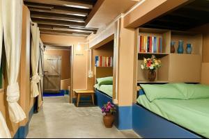 a small room with two beds and bookshelves at Holiday cabin in Sibey in Hāpoli