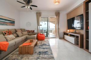 a living room with a couch and a tv at Casa BuenaVista Calpe in Casas de Torrat