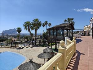 a view of a resort with a pool and a gazebo at Casa BuenaVista Calpe in Casas de Torrat