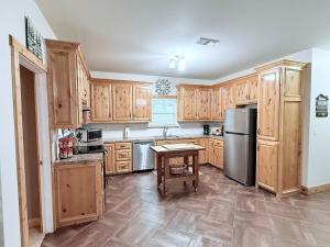 a kitchen with wooden cabinets and a stainless steel refrigerator at Carlene's Place in Kingston