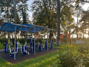 a playground with blue equipment in a park at Chalet Marta in Kobuleti