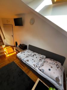 a bed sitting in a room with a stair case at Penzión Dvorec in Dvorec +31 photos