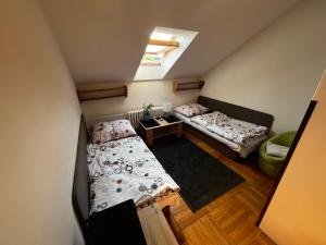 a small room with two beds and a window at Penzión Dvorec in Dvorec