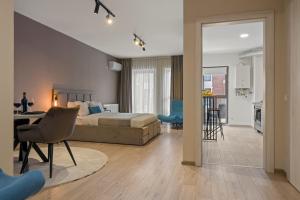 a bedroom with a bed and a living room at Studio 6 in Bucharest