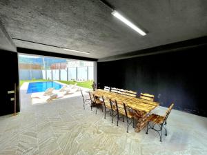 a dining room with a table and chairs and a pool at Mountain Nest Challet in Gabala