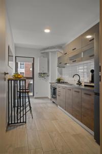 a large kitchen with wooden cabinets and a counter at Studio 6 in Bucharest