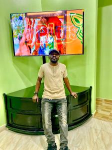 a man standing in front of a green bench at SafinaAirbnbApartment in Dodoma