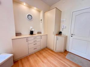 a bedroom with white cabinets and a white door at Elegant and bright flat in a quiet area in Rīga +8 photos