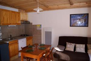 a living room with a couch and a table at Appartement la Cascade in Allos