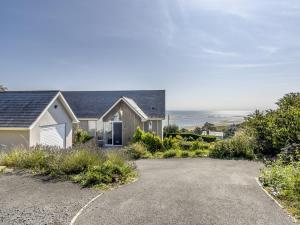 ein Haus mit einer Auffahrt davor in der Unterkunft Verbier Luxurious Seaside Retreat in Aberdyfi