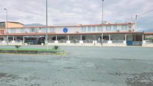 an empty street in front of a building at Hotel paradiso in Scalea