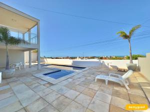 a house with a patio with a view of the ocean at Beach Townhouses IV in Mangabeira