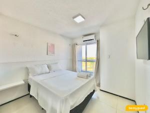 a white room with a bed and a window at Beach Townhouses IV in Mangabeira +50 photos
