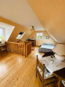 a attic room with two beds and a staircase at Family home 7 people, direct beach, sea view in Locquirec