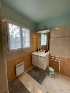 a bathroom with a sink and a mirror at Family home 7 people, direct beach, sea view in Locquirec