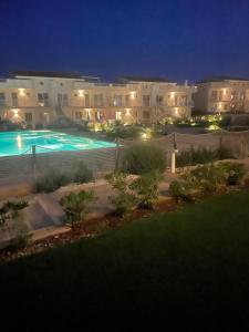 a view of a swimming pool at night at Ortensia Apartment in Pachino