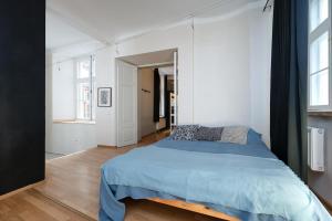 a bedroom with a bed with a blue comforter at 12 guests, 70m2, center of Old Town, Wi-Fi, Streaming in Tallinn