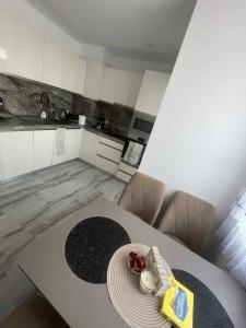 a kitchen with a table with a plate on it at 2 Bedroom apartment in Gotse Delchev +3 photos