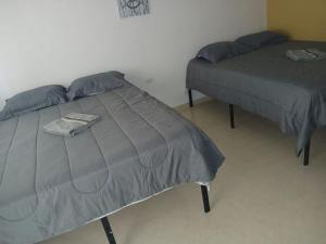 two beds sitting in a room with at jackys culebra apartment in Culebra