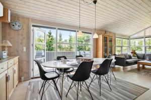 a kitchen and living room with a table and chairs at JB792-Fjerritslev-Egevej-34 in Fjerritslev +17 photos
