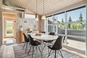 a kitchen and dining room with a table and chairs at JB792-Fjerritslev-Egevej-34 in Fjerritslev