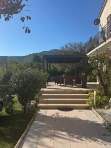 a set of stairs leading to a patio with tables and chairs at Bnb Castellane Chambre d'Hotes B&B in Castellane +23 photos