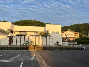 a parking lot in front of a building at Onomichi Villa Ayah in Onomichi