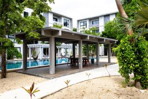 a pavilion with a table in front of a building at Hotel Casa Tortuga Tulum - Cenotes Park Inclusive in Tulum
