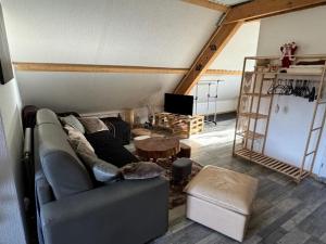 a living room with a couch and a table at Gîte de la Source de la Bruche in Bourg-Bruche