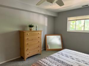 a bedroom with a dresser and a mirror at Pet-friendly 1br Condo Free Parking, Discount! in Cheltenham Village
