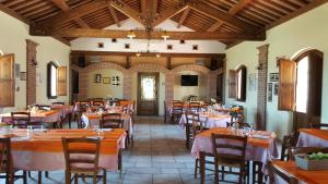 a restaurant with tables and chairs in a room at I Dolci Grappoli in Larino