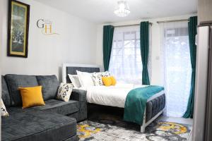 a living room with a bed and a couch at Gray Havens Homes in Rungiri