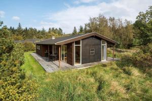 a small house with a deck in a field at JB242-Fjerritslev-Poppelvej-8 in Fjerritslev